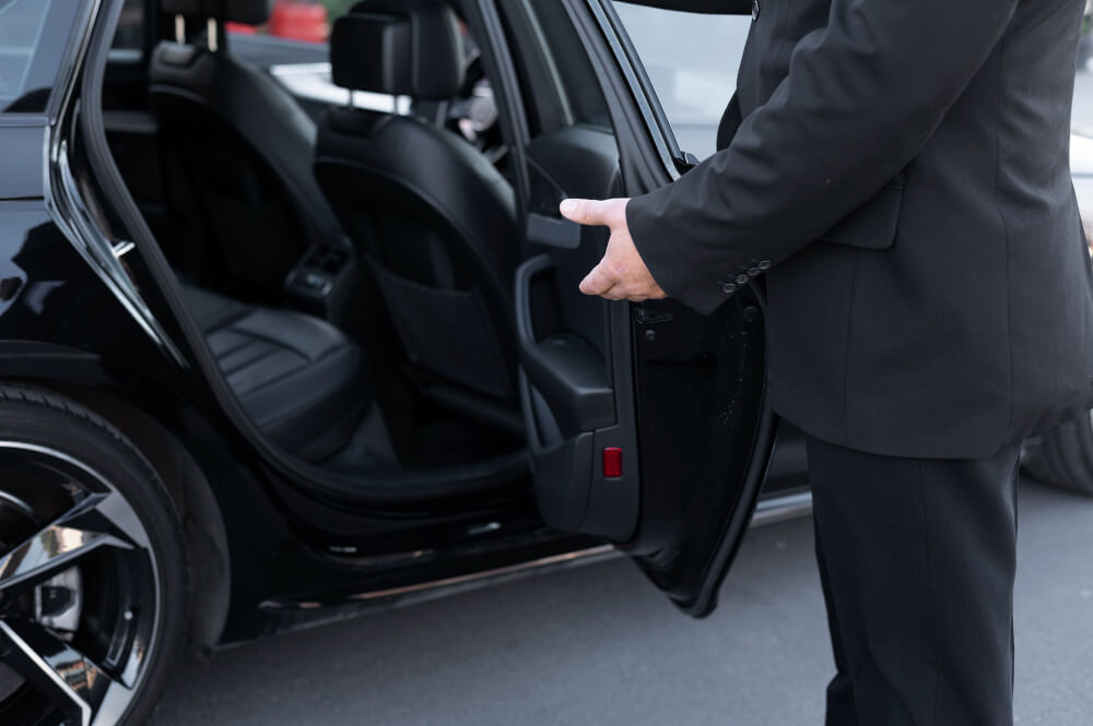 Chauffeur opening passenger side car door